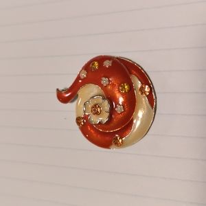 Orange and cream colored pendant.